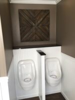 Black Tie restroom trailer luxury interior with trim, wood paneling and painted walls