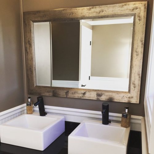 Black Tie Luxury restroom trailers interior with upgraded sinks, a mirror, trim, wood floors and light fixtures
